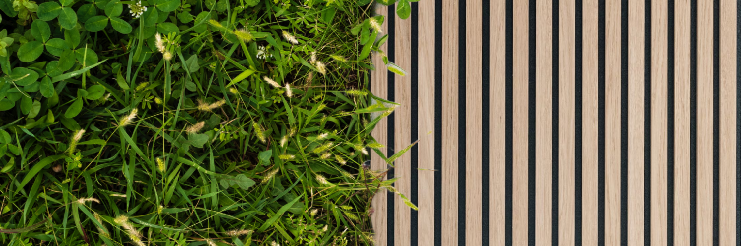 A wooden board adorned with lush grass and plants, showcasing eco-friendly wooden panels for walls in a natural setting.