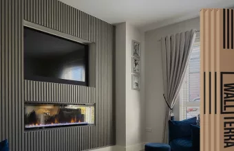 A cozy living room featuring a fireplace, large television, and elegant wooden wall paneling for a warm ambiance.