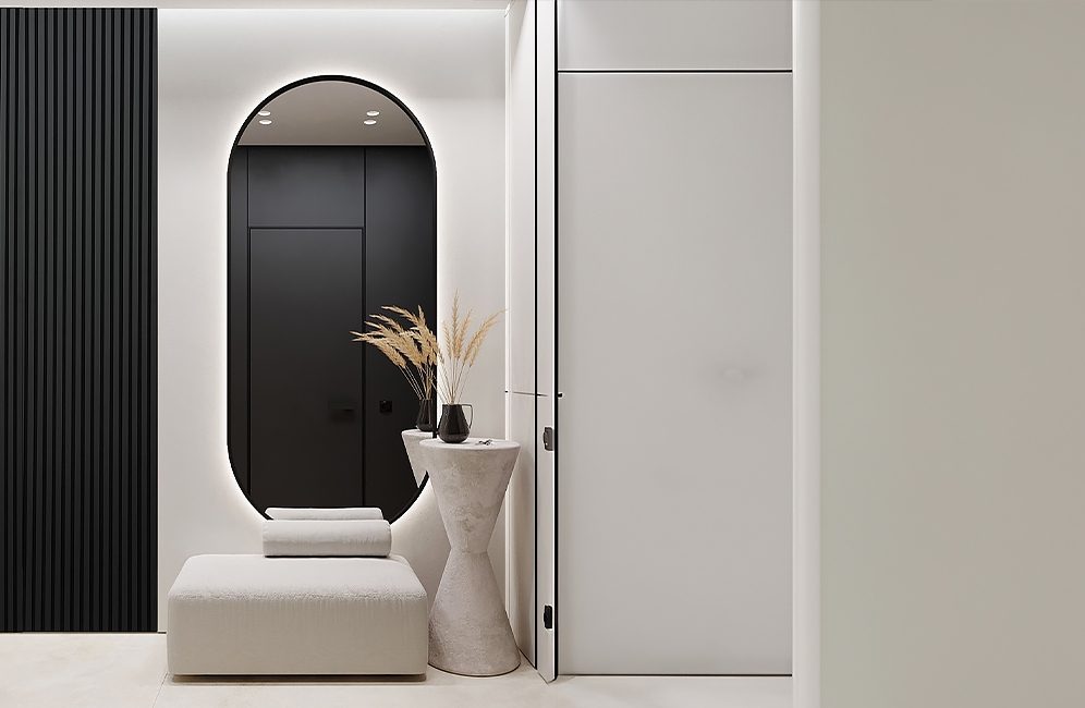 A sleek modern bathroom featuring a striking black accent wall and a stylish black and white design throughout.