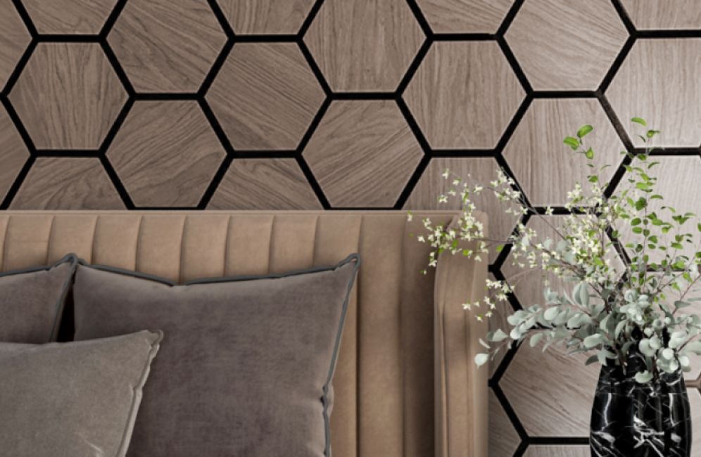 A modern bedroom with a bed, a vase, and a wall featuring premium hexagon acoustic panels, combining style and functionality.