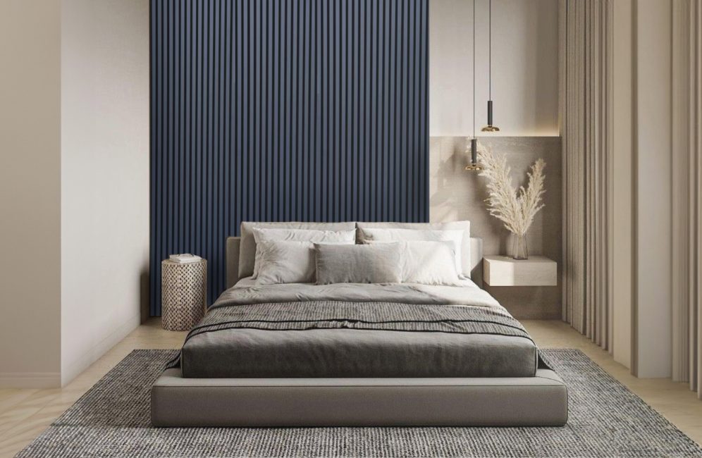 A modern bedroom with a blue striped wall and a well-arranged bed, illustrating the concept of an accent wall.